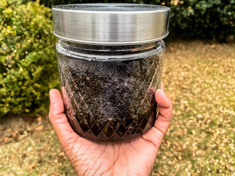 Glass Jar of Used Coffee Grounds for Composting