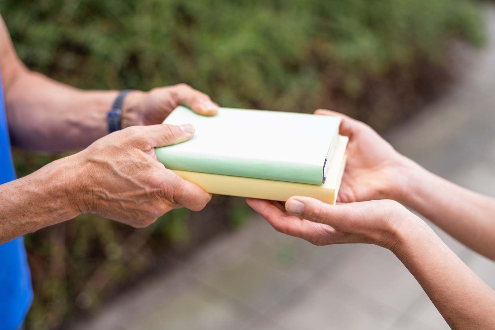 Sharing Books. Hand Closeup Giving Book