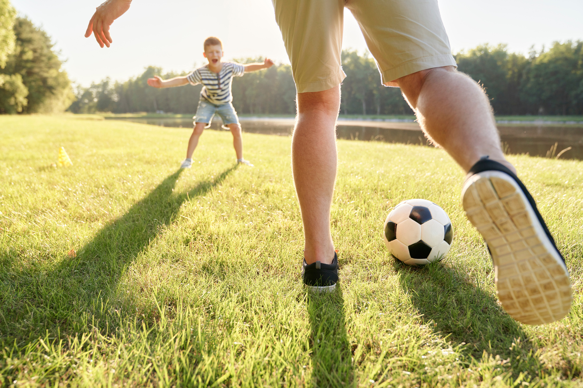 Father and Son Playing Soccer Outdoors